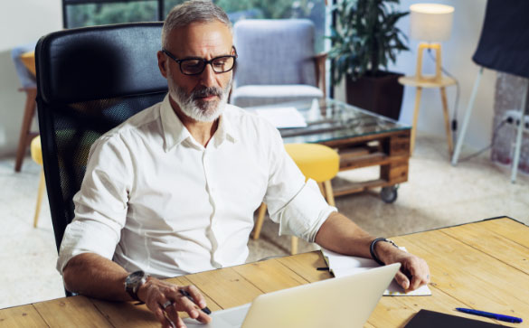 Man working on computer wearing Blumax lenses