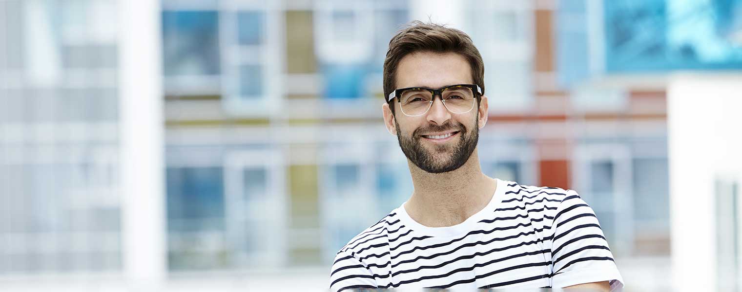 Man outdoors wearing glasses