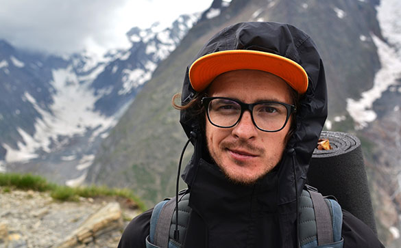 Young man hiking in the mountains