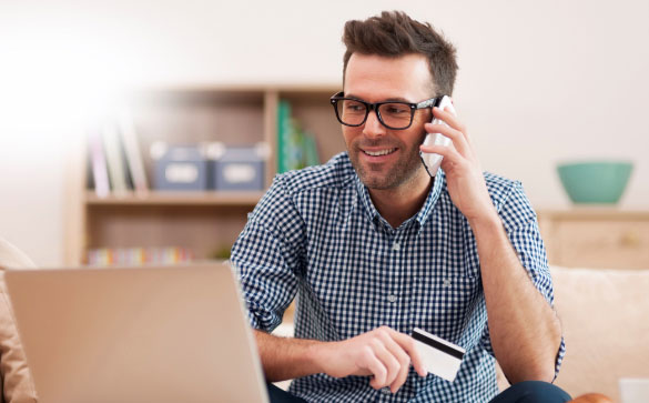 Man wearing glasses with Satin Blue working on computer