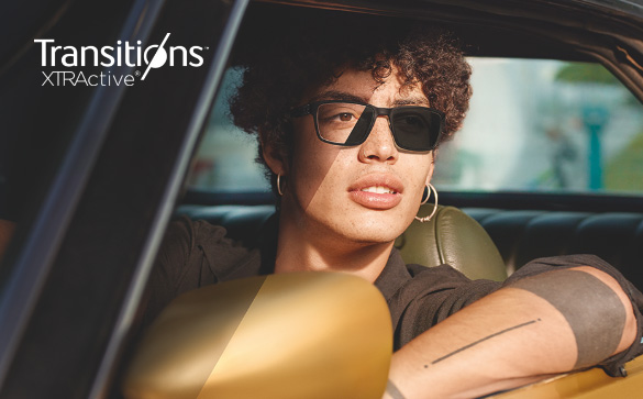 Man in a car wering Transitions XTRActive lenses